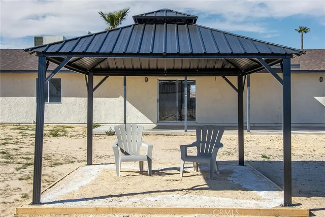 a view of a patio with table and chairs with wooden floor and fence