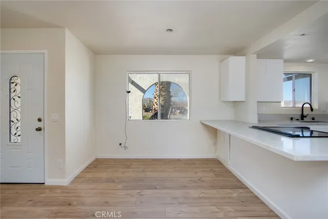 a view of a kitchen with a sink and dishwasher wooden floor