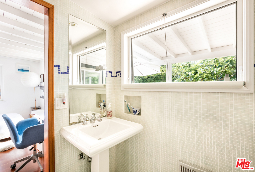 232 West Channel Road Santa Monica, CA 90402 - Photo 8 of 12 a bathroom with a sink and a mirror