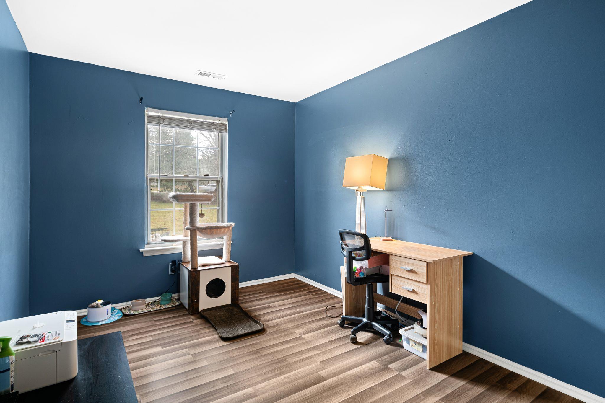 505 A Ralston Drive, Unit A Mount Laurel, NJ 08054 - Photo 14 of 18 a room with gym equipment on wooden floor and a window