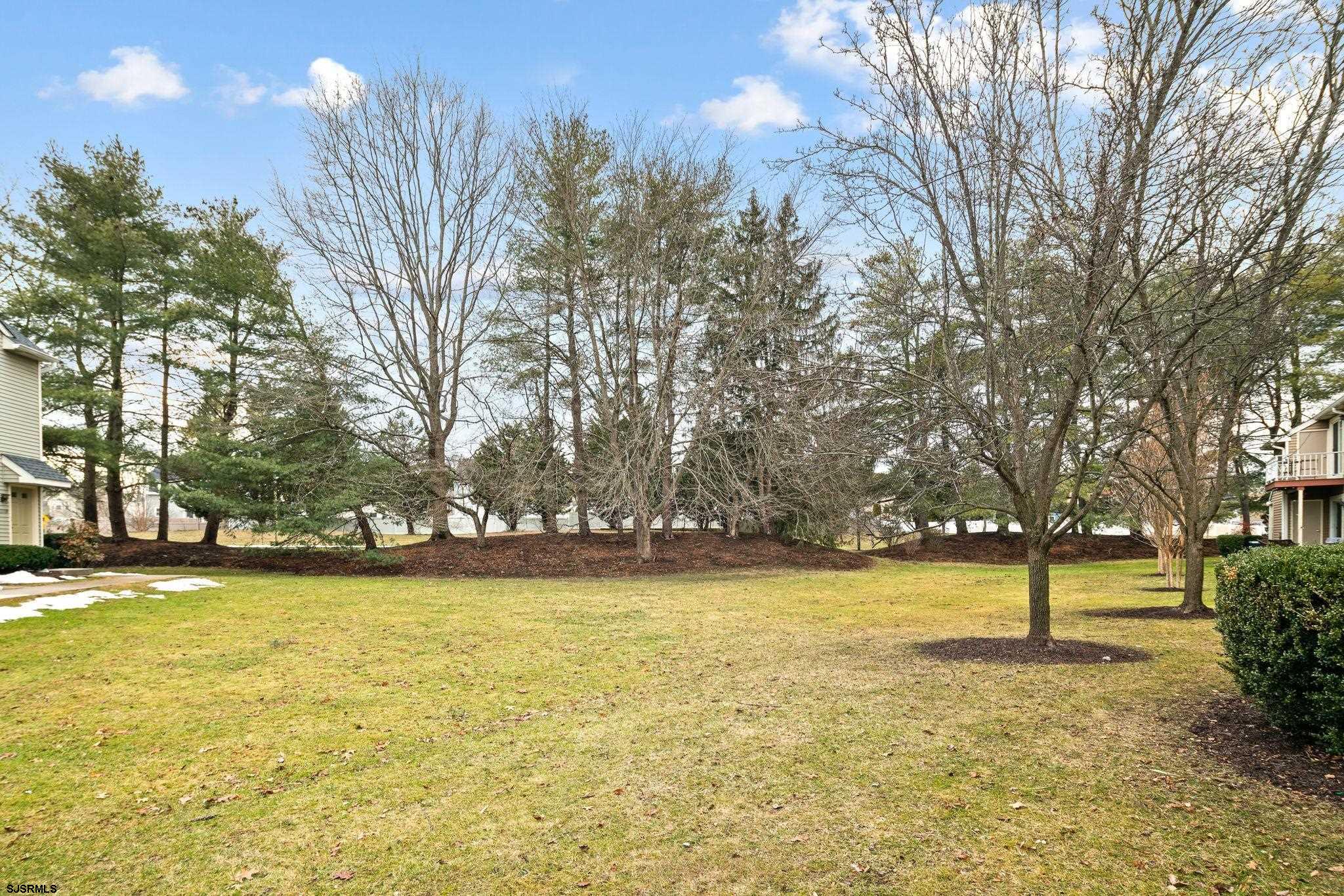 505 A Ralston Drive, Unit A Mount Laurel, NJ 08054 - Photo 17 of 18 a view of a swimming pool and trees in the background