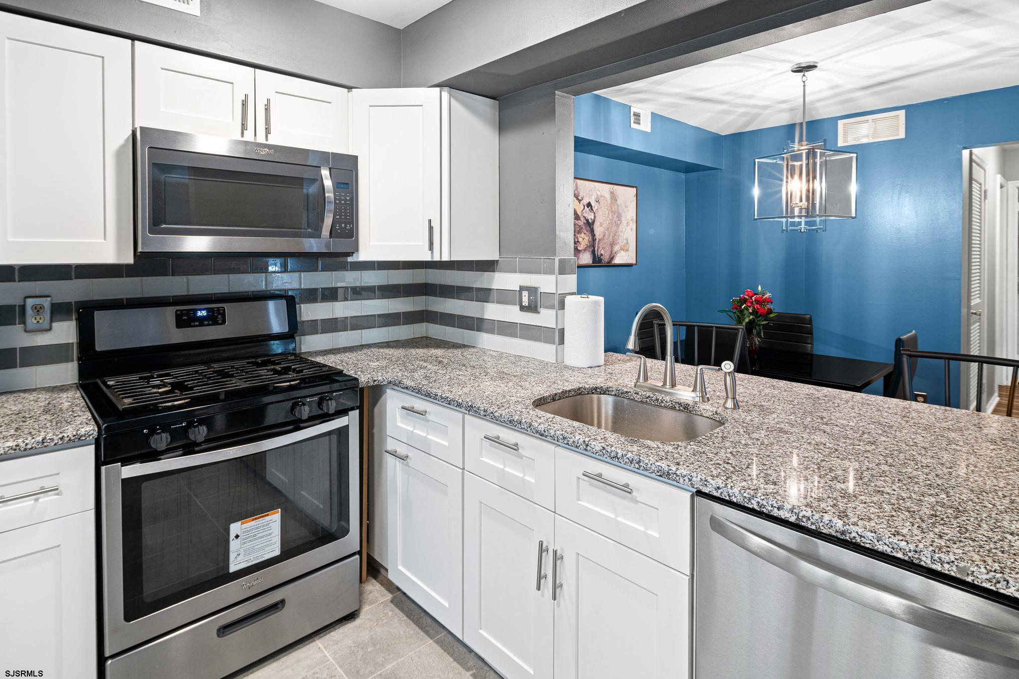 505 A Ralston Drive, Unit A Mount Laurel, NJ 08054 - Photo 4 of 18 a kitchen with granite countertop a stove and a microwave