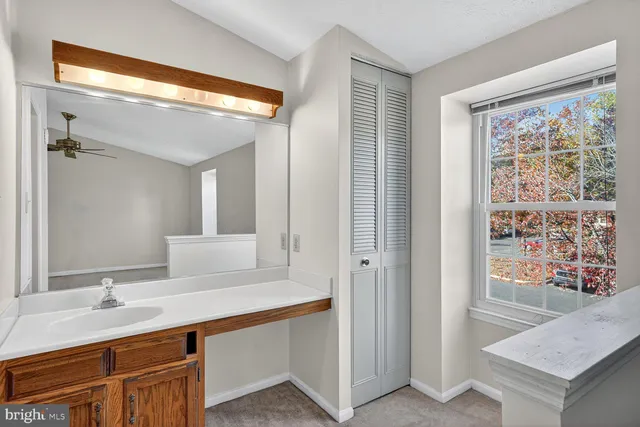 a bathroom with a sink a mirror and a shower