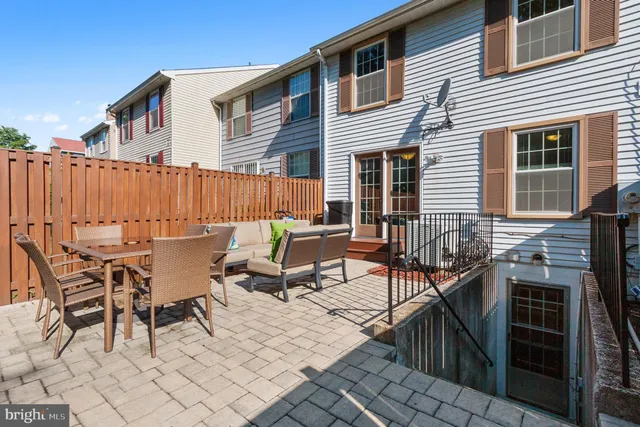 a view of backyard with outdoor seating and trees