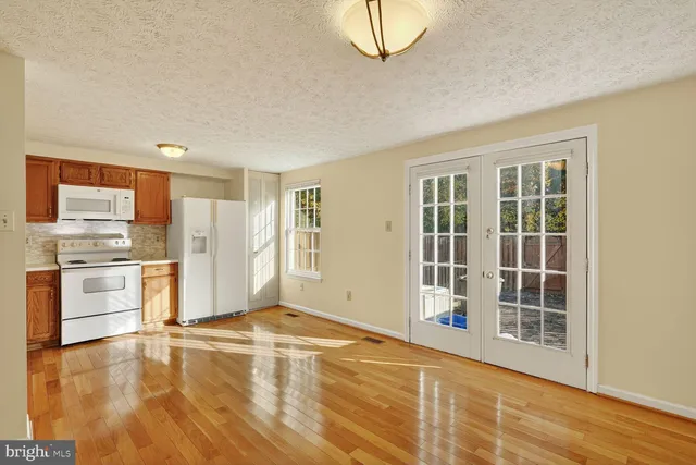 a view of a kitchen with a stove top oven
