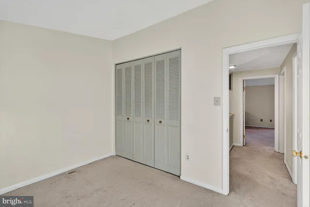 an empty room with closet area