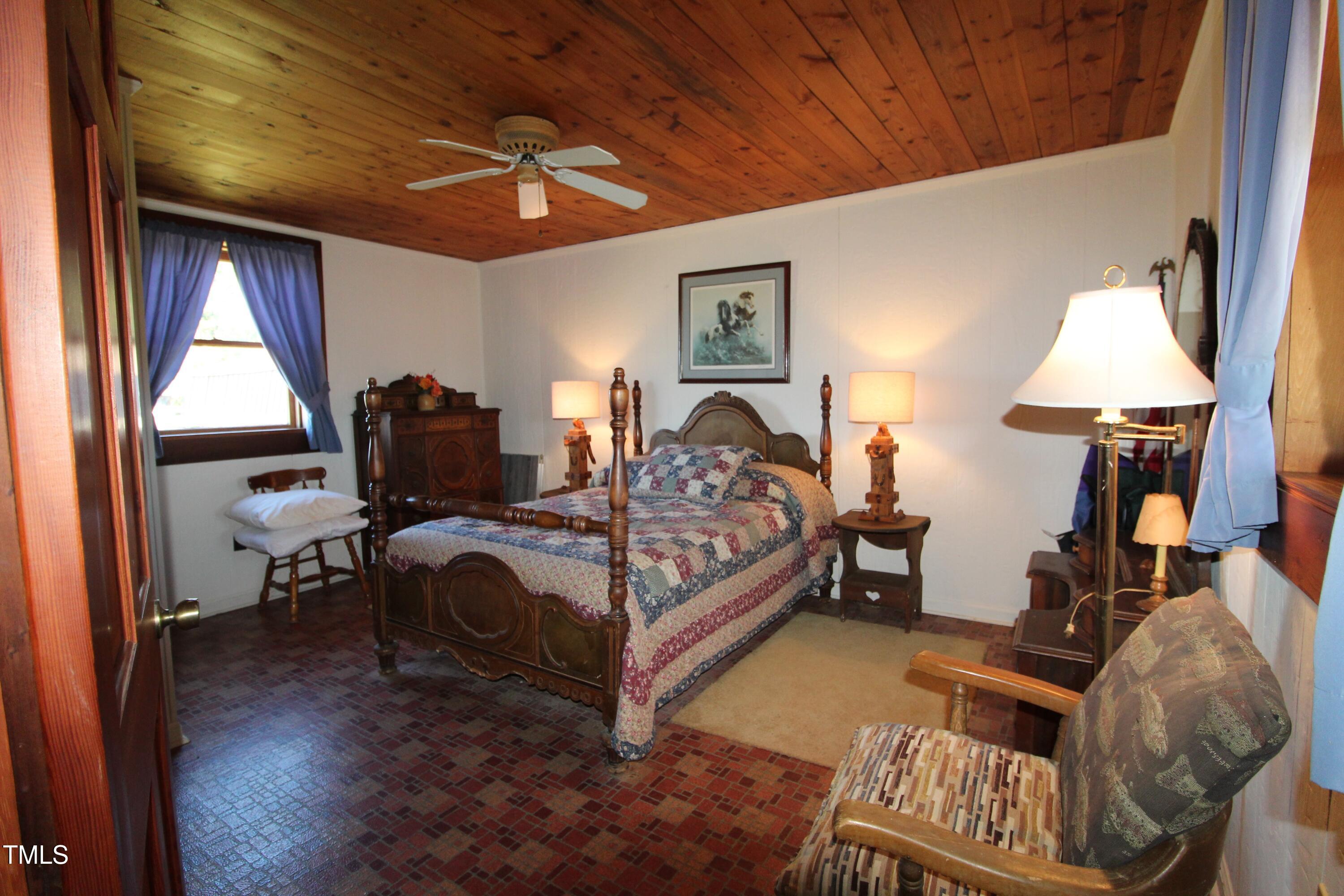 455 Hogan Farm Road Seagrove, NC 27341 - Photo 55 of 70 a bedroom with furniture and a window