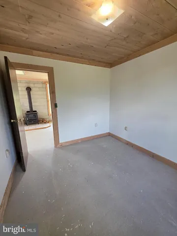 a view of a big room with wooden floor and windows