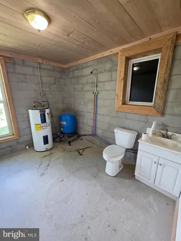 a bathroom with a sink toilet and mirror