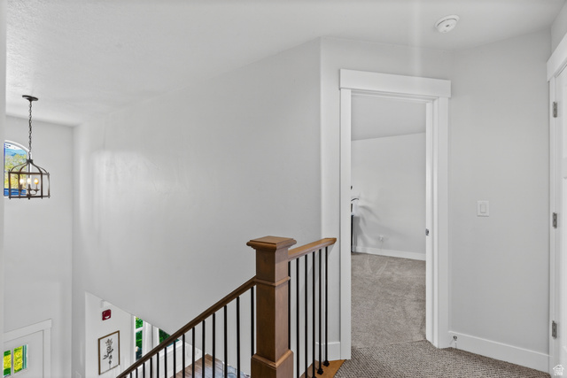 681 Island Road Morgan, UT 84050 - Photo 15 of 49 Staircase featuring wood-finish handrail, black balusters, and white risers