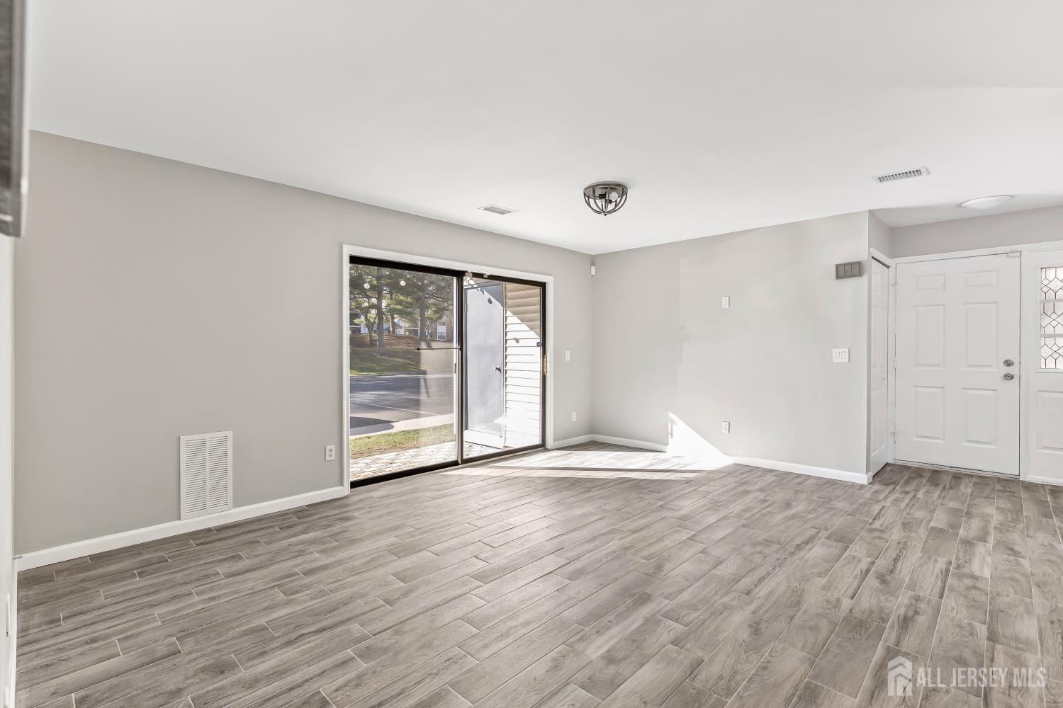 2301 Bayhead Drive Parlin, NJ 08859 - Photo 12 of 18 a view of an empty room with wooden floor and a window