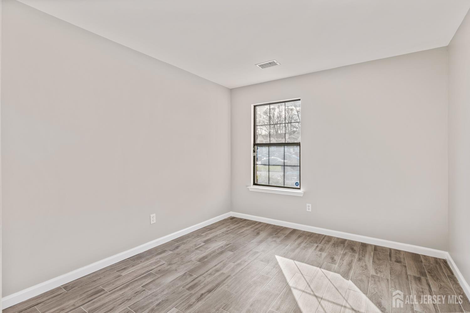 2301 Bayhead Drive Parlin, NJ 08859 - Photo 18 of 18 an empty room with wooden floor and windows