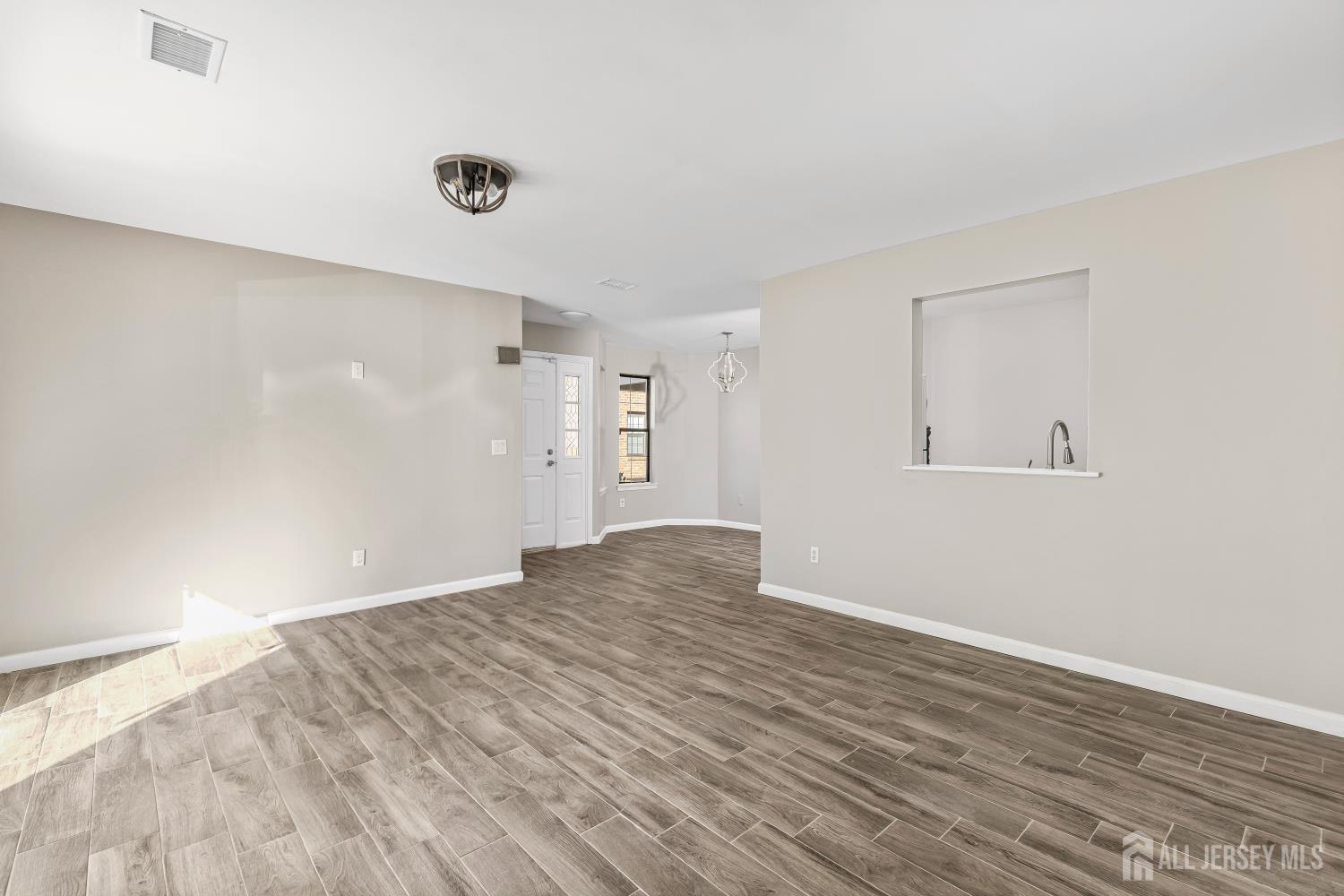 2301 Bayhead Drive Parlin, NJ 08859 - Photo 6 of 18 a view of empty room with wooden floor and fan