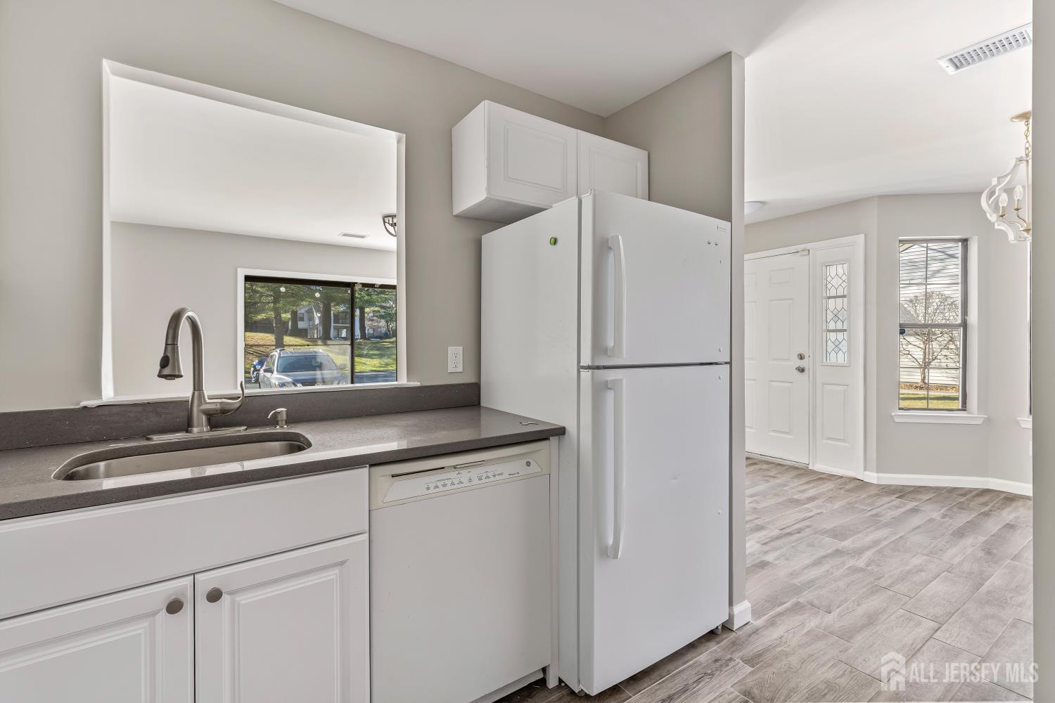 2301 Bayhead Drive Parlin, NJ 08859 - Photo 8 of 18 a kitchen with a refrigerator and a sink
