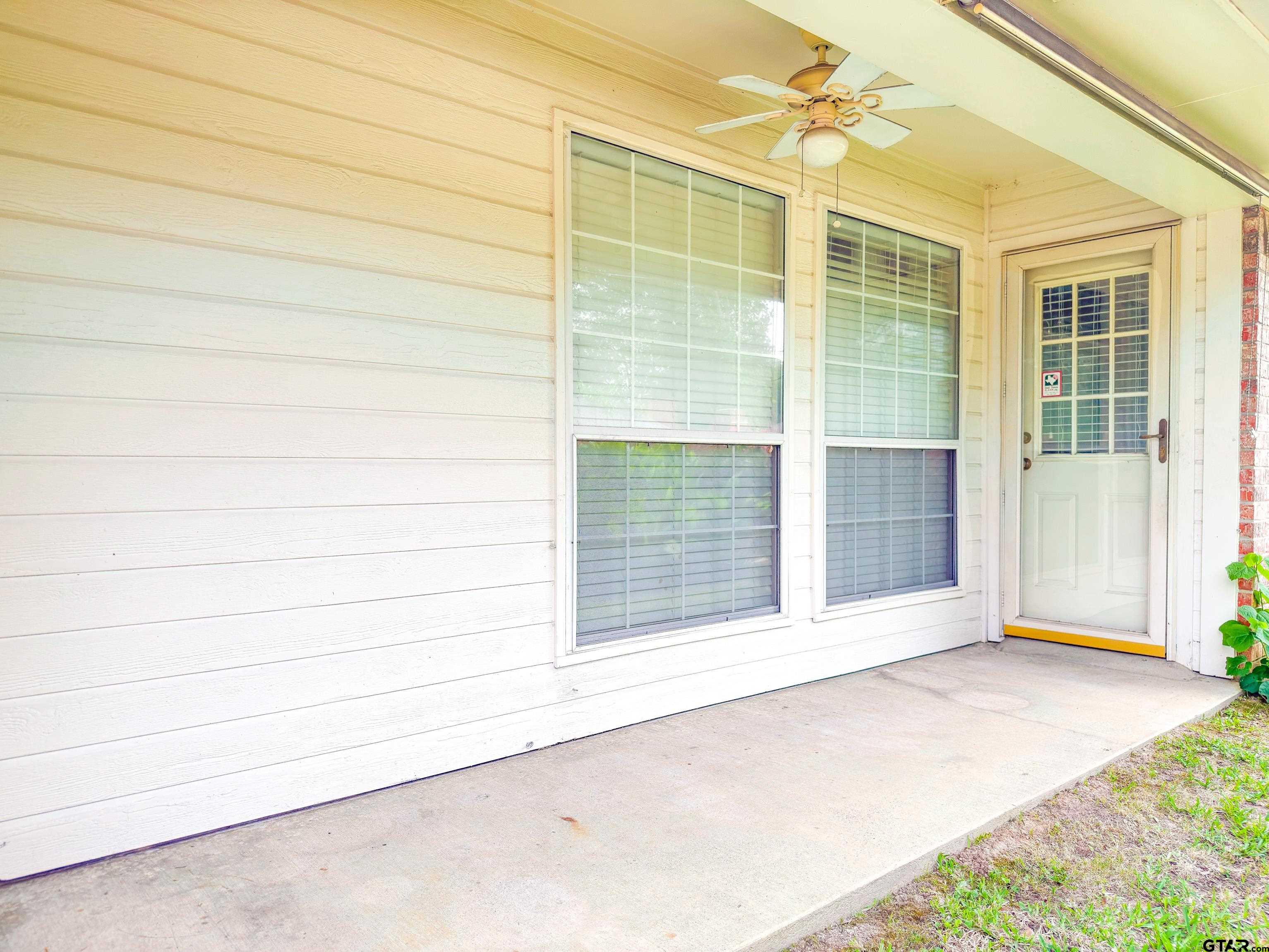 1202 Rice Road, Unit 112 Tyler, TX 75703 - Photo 12 of 12 a view of an empty room with a window