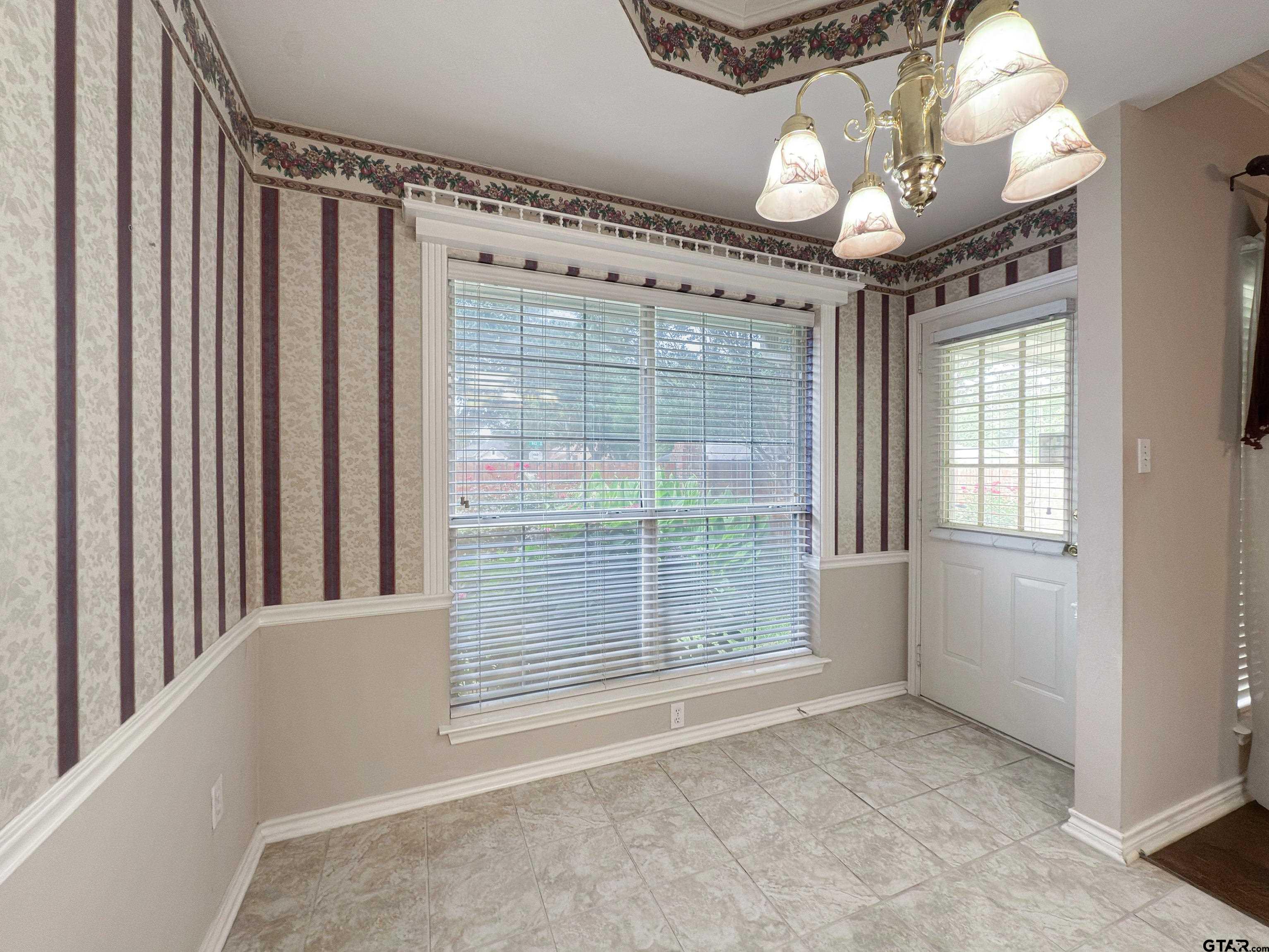 1202 Rice Road, Unit 112 Tyler, TX 75703 - Photo 4 of 12 a view of an empty room with a window