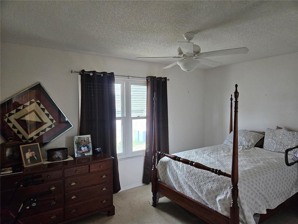 8480 Southwest 61st Terrace Road Ocala, FL 34476 - Photo 12 of 26 a bed room with a bed and a window
