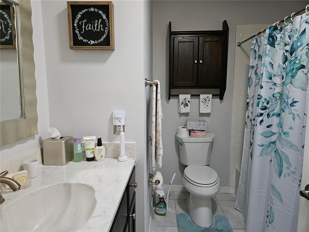 8480 Southwest 61st Terrace Road Ocala, FL 34476 - Photo 13 of 26 a bathroom with a toilet sink and mirror
