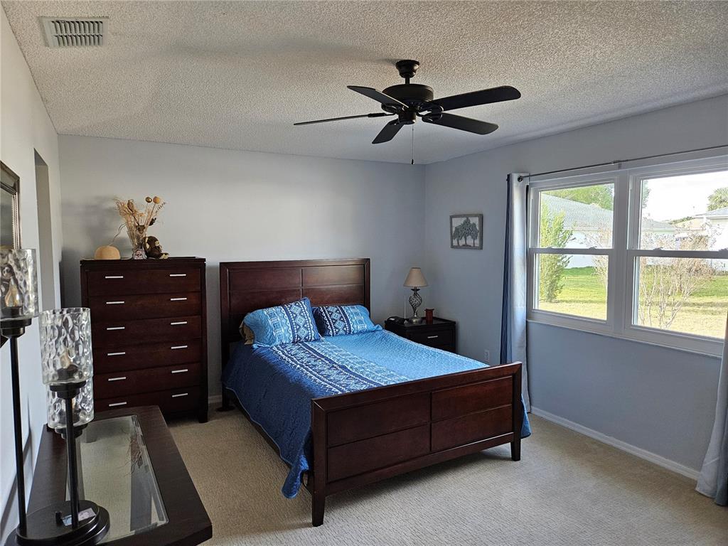 8480 Southwest 61st Terrace Road Ocala, FL 34476 - Photo 14 of 26 a bedroom with a bed and a window
