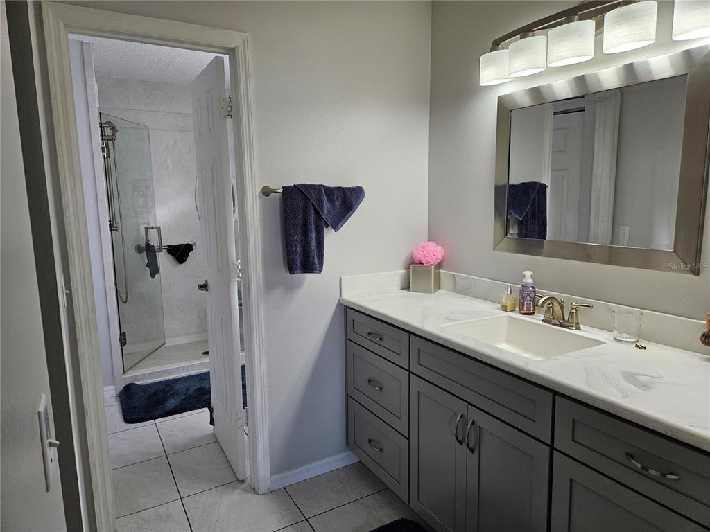 8480 Southwest 61st Terrace Road Ocala, FL 34476 - Photo 15 of 26 a bathroom with a double vanity sink mirror and shower