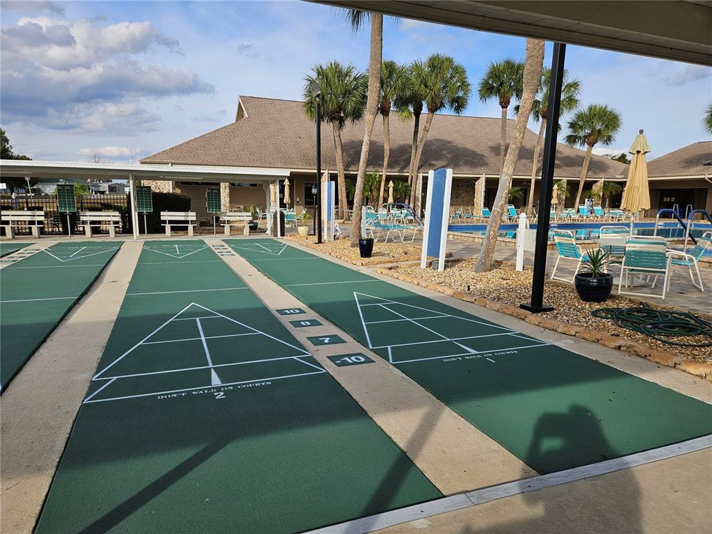8480 Southwest 61st Terrace Road Ocala, FL 34476 - Photo 23 of 26 a view of a patio with table and chairs under an umbrella