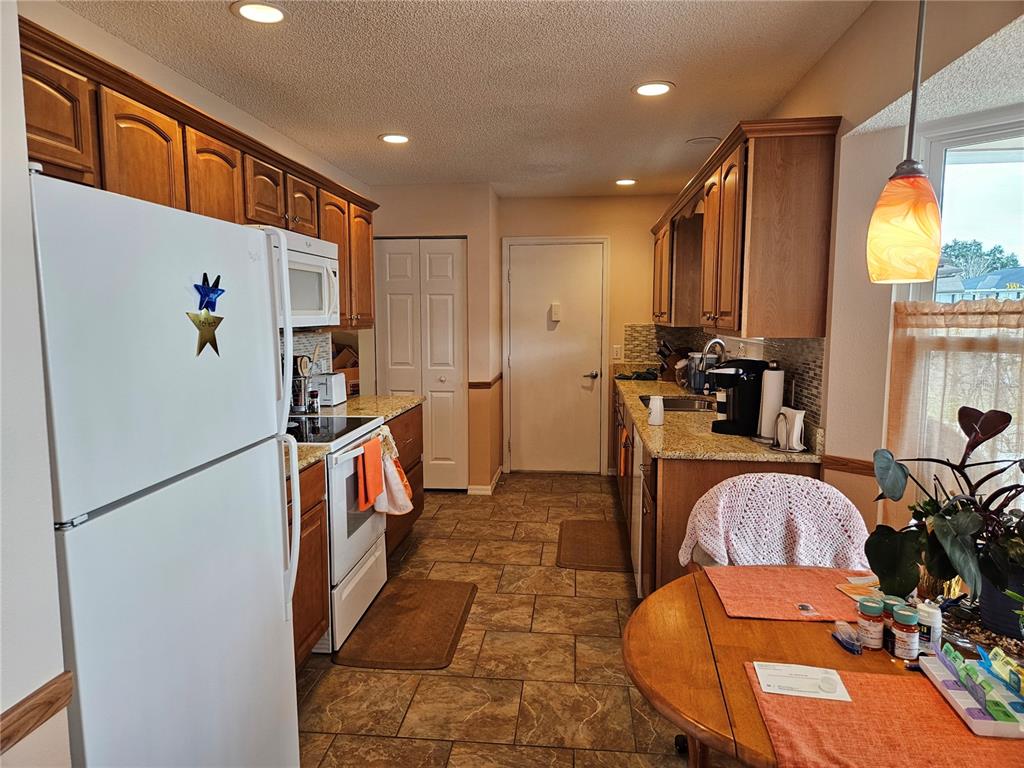 8480 Southwest 61st Terrace Road Ocala, FL 34476 - Photo 4 of 26 a kitchen with stainless steel appliances a refrigerator and a stove