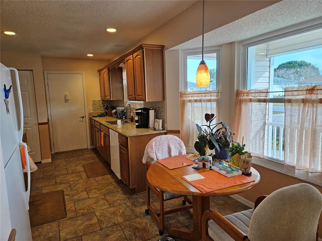 8480 Southwest 61st Terrace Road Ocala, FL 34476 - Photo 5 of 26 a dining room with furniture and a window