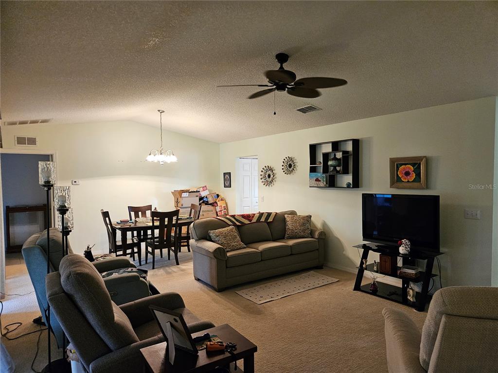 8480 Southwest 61st Terrace Road Ocala, FL 34476 - Photo 9 of 26 a living room with furniture and a flat screen tv
