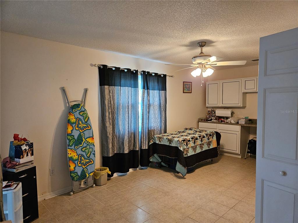 8480 Southwest 61st Terrace Road Ocala, FL 34476 - Photo 10 of 26 a living room with furniture and a flat screen tv
