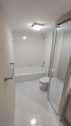 a bathroom with a tub and a sink
