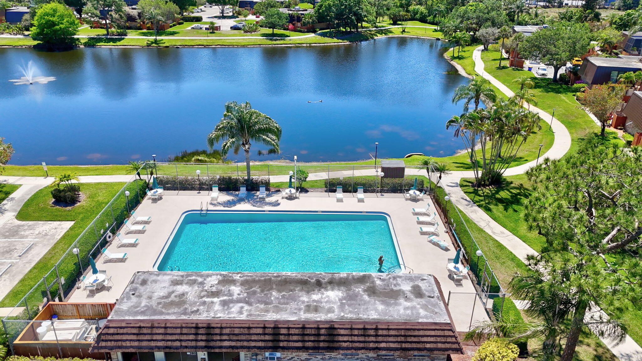 5646 Southeast Windsong Lane, Unit 415 Stuart, FL 34997 - Photo 16 of 20 a view of a lake with a building in the background