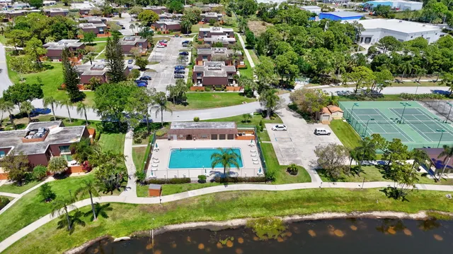 an aerial view of residential houses with outdoor space and trees