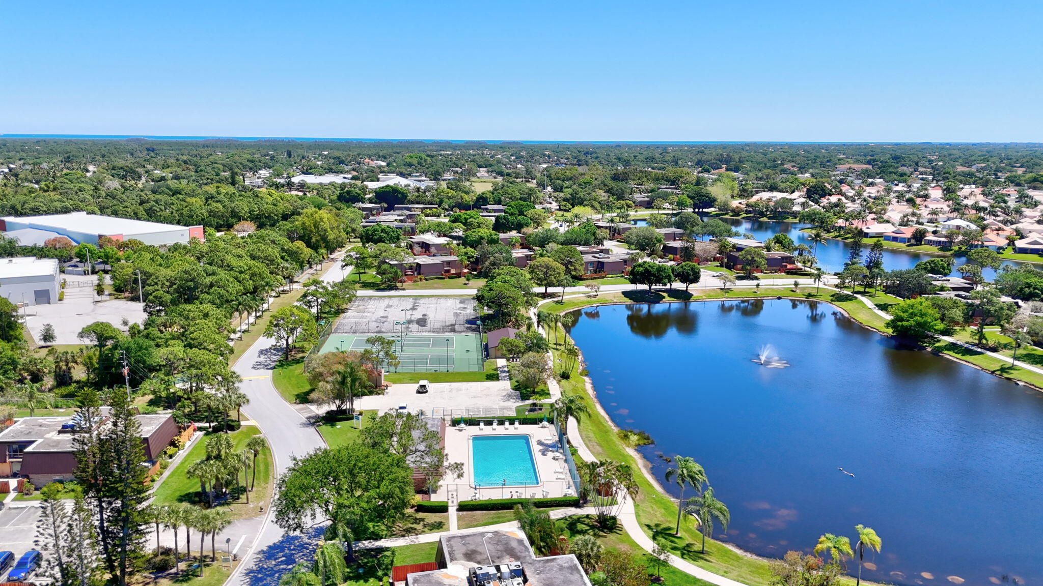 5646 Southeast Windsong Lane, Unit 415 Stuart, FL 34997 - Photo 18 of 20 an aerial view of residential houses with outdoor space