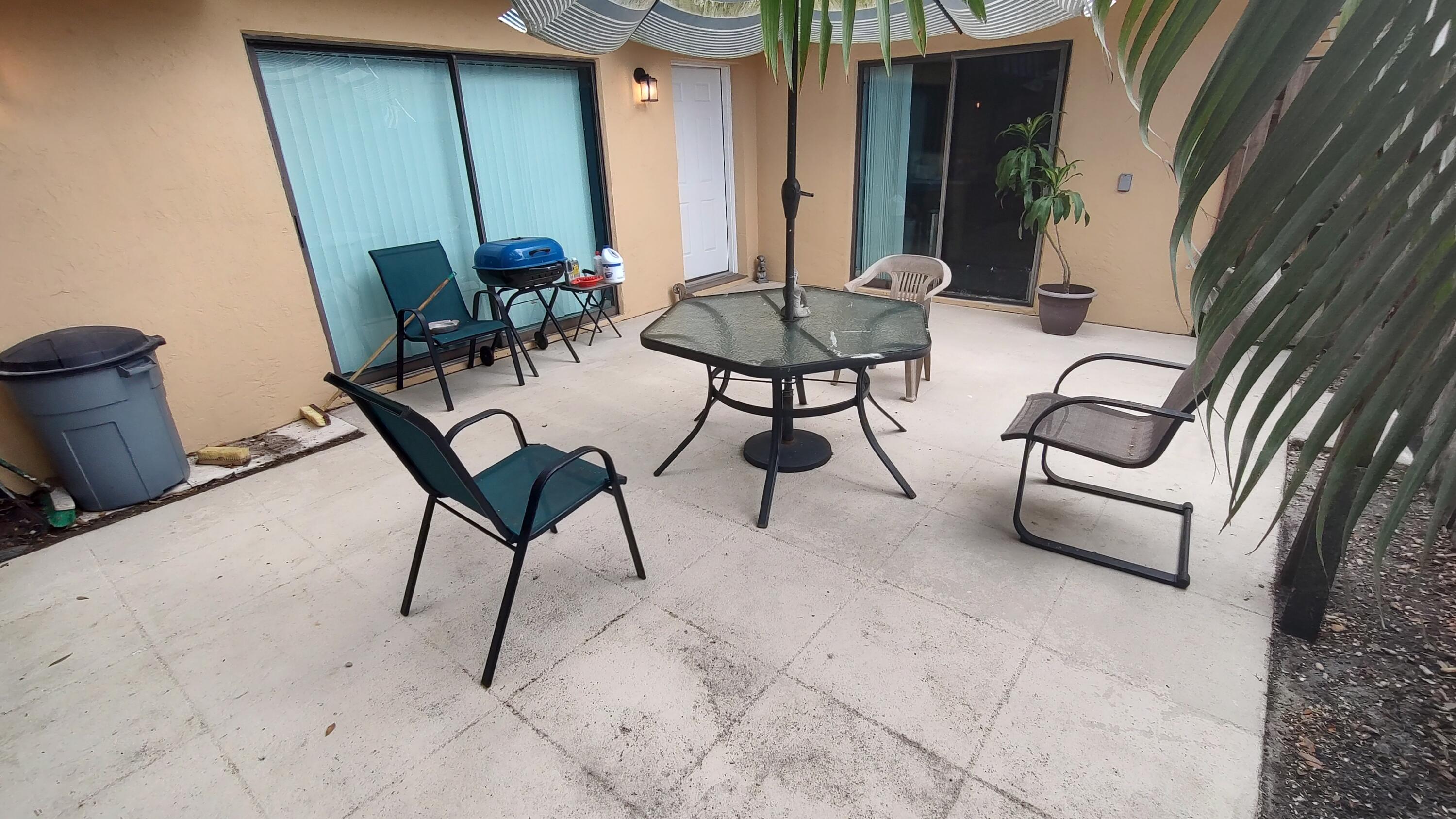 5646 Southeast Windsong Lane, Unit 415 Stuart, FL 34997 - Photo 3 of 20 a view of an outdoor space with seating area