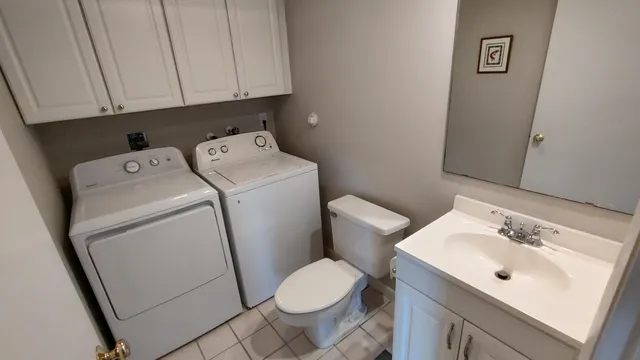 a bathroom with a sink toilet and vanity