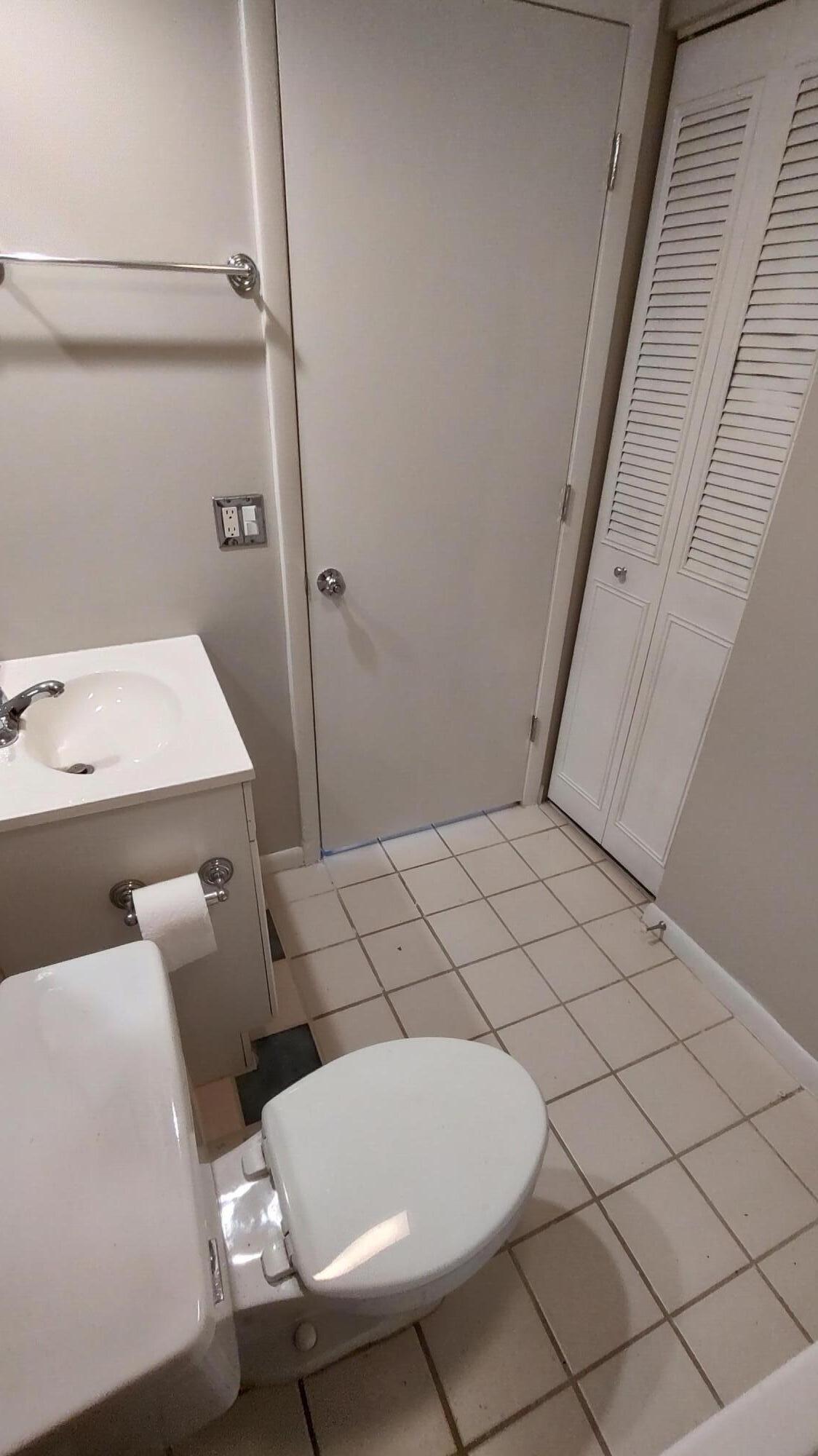 5646 Southeast Windsong Lane, Unit 415 Stuart, FL 34997 - Photo 7 of 20 a bathroom with a sink and toilet