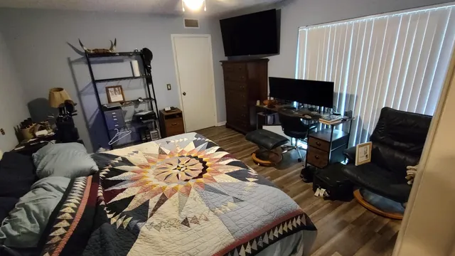 a view of a livingroom with furniture and a flat screen tv