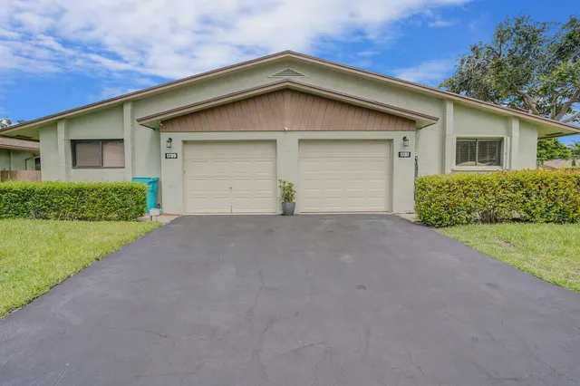 a view of a house with a yard and garage