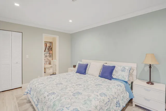 a bedroom with a bed and a night stand