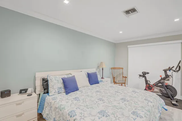 a bedroom with a bed and a lamp