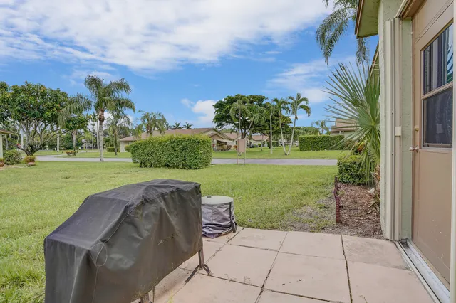 a view of a garden with a building in the background