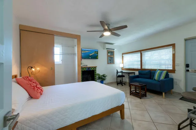 a bedroom with a bed a couch and dresser