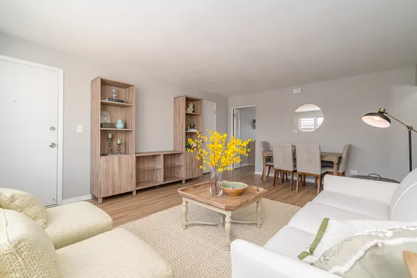 a living room with furniture and wooden floor
