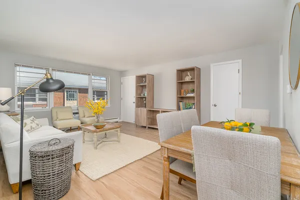 a living room with furniture and wooden floor