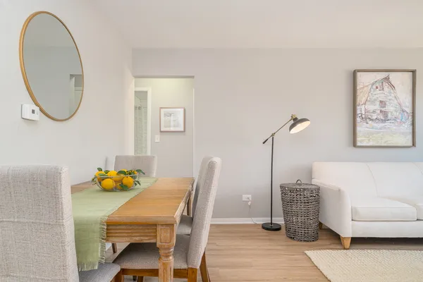 a dining room with furniture and a mirror