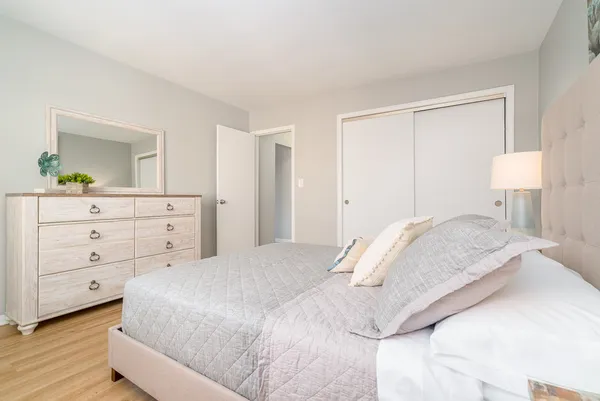 a bedroom with a bed and a dresser