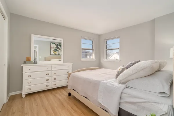 a bedroom with a bed and a dresser
