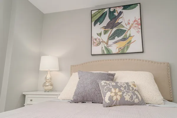 a bedroom with a bed and wall painting