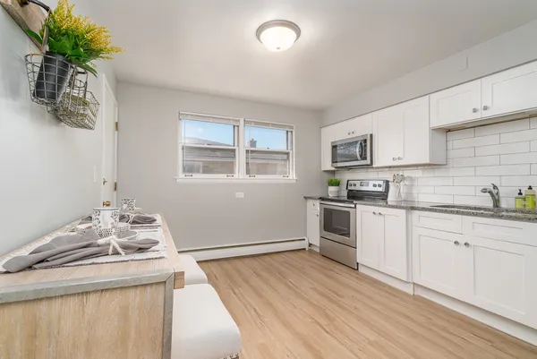 a kitchen with a sink stove and cabinets