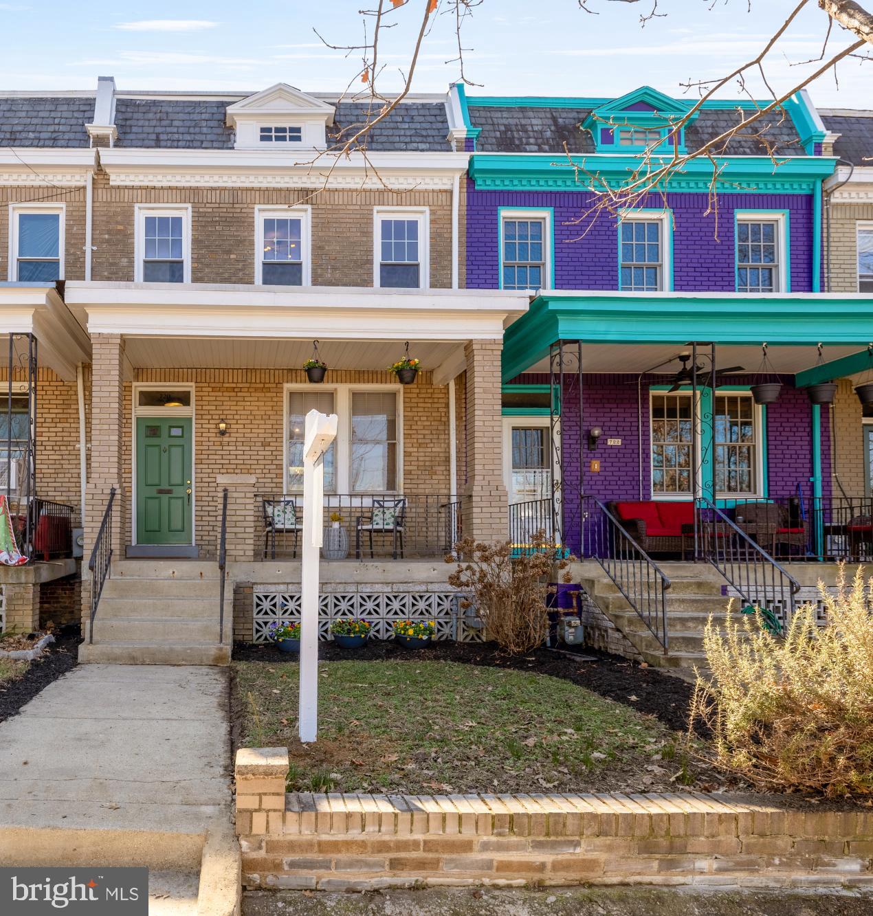 a view of a brick building with a fountain in front of it